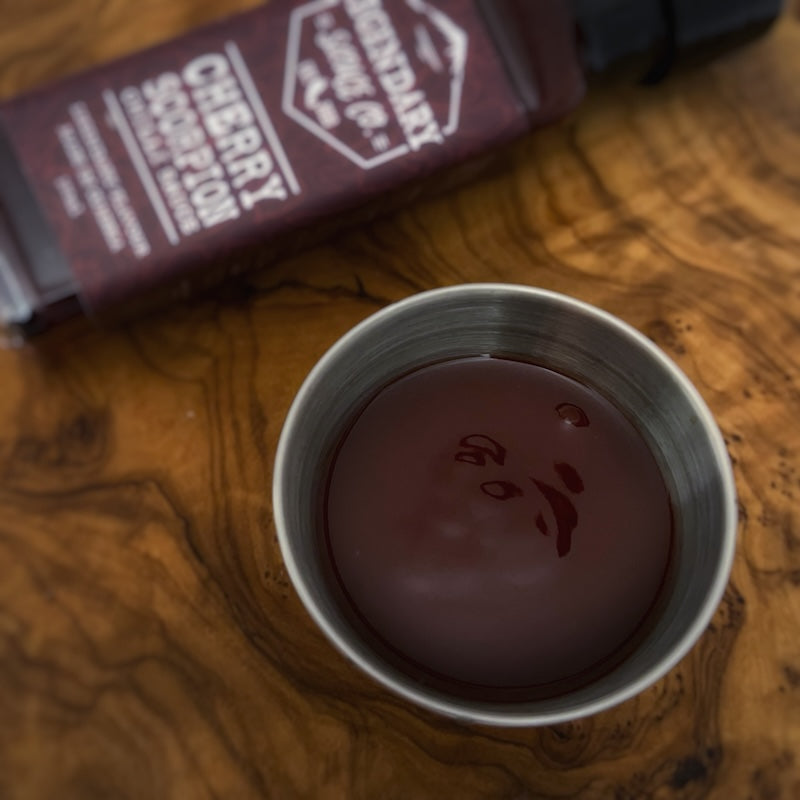 A small tub of hot sauce