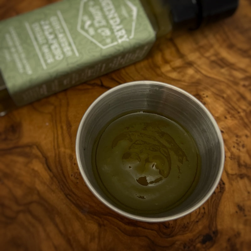 A small tub of hot sauce