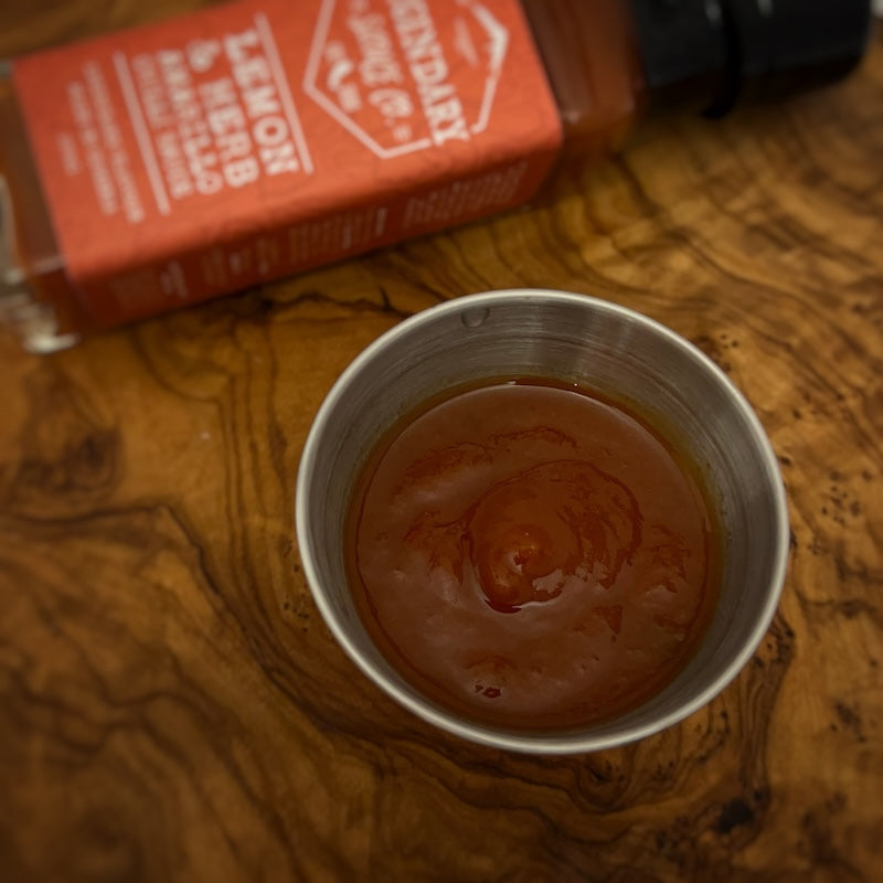 A small tub of hot sauce