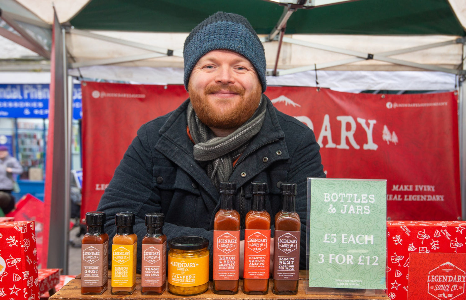 A market trader selling hot sauce