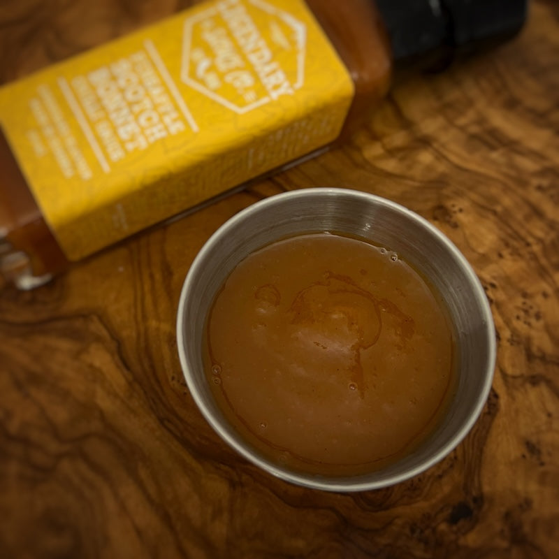 A small tub of hot sauce