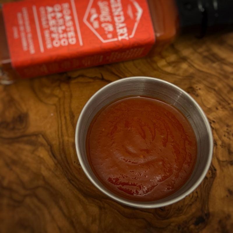 A small tub of hot sauce