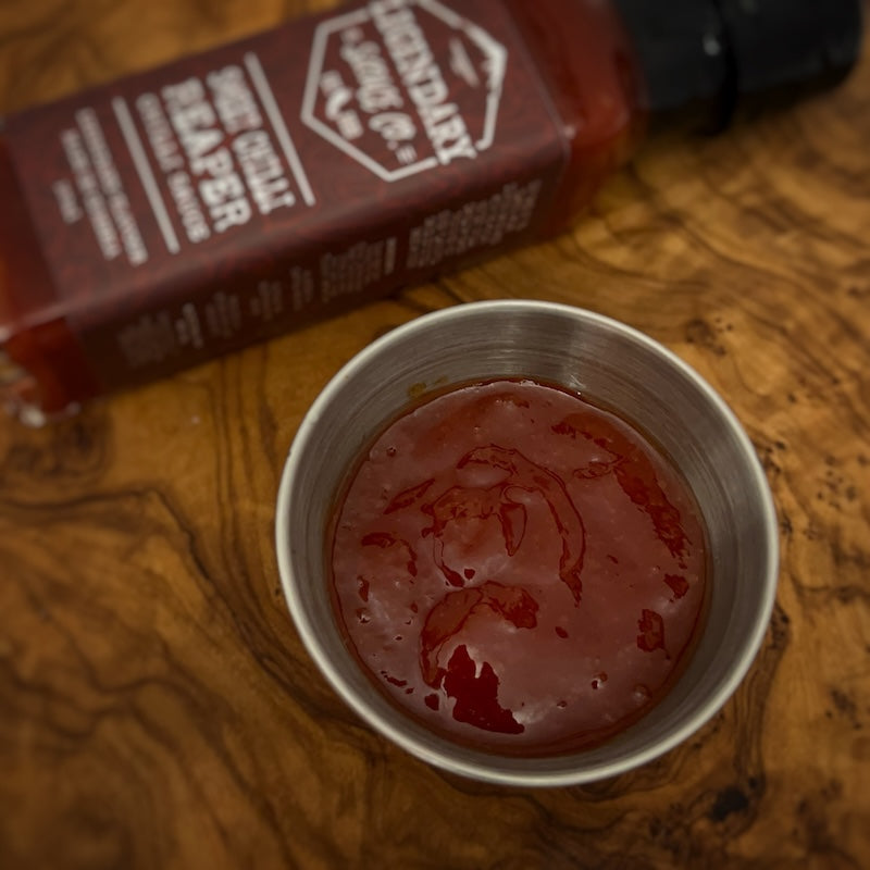 A small tub of hot sauce