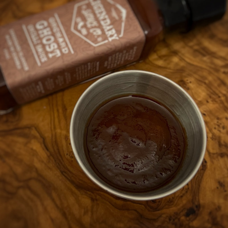 A dish contain brown hot sauce