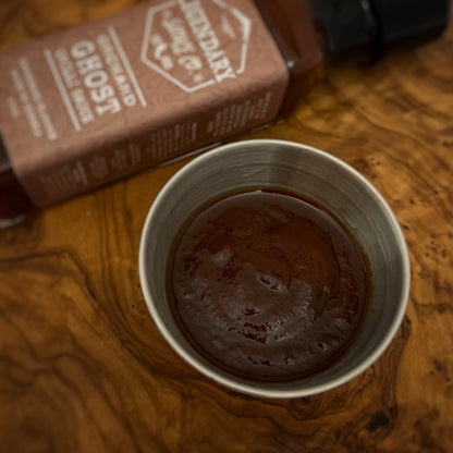A dish contain brown hot sauce