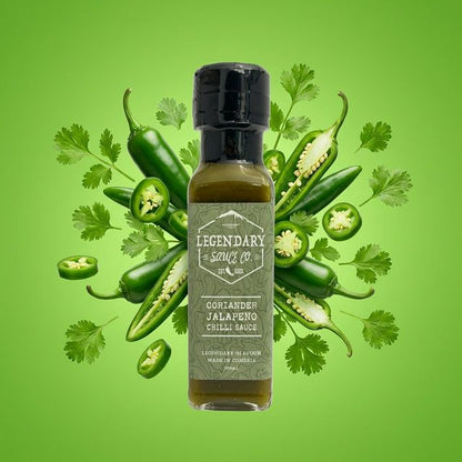 Bottle of Legendary Sauce Co. Coriander Jalapeno Chilli Sauce surrounded by jalapenos and cilantro on a green background