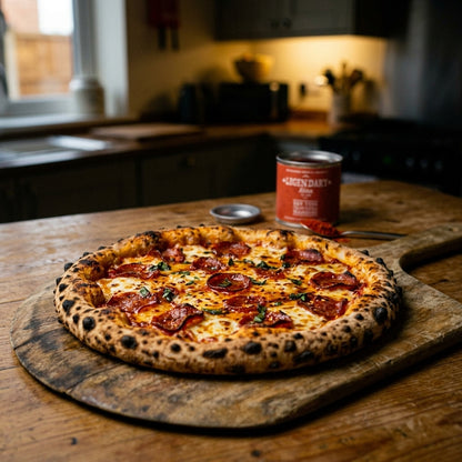 Pepperoni pizza on a wooden board with a can of beer in a kitchen setting