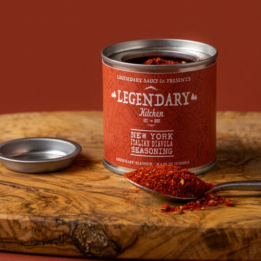 Can of Legendary Kitchen New York Italian Diana seasoning on a wooden surface with a spoonful of seasoning.